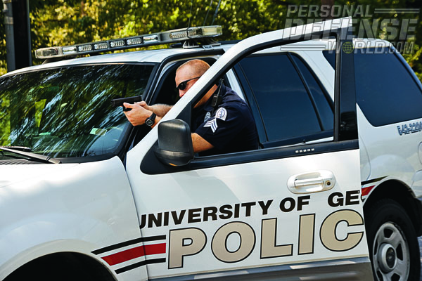 traffic stops. This U of GA officer stands ready with his GLOCK behind vehicle cover.