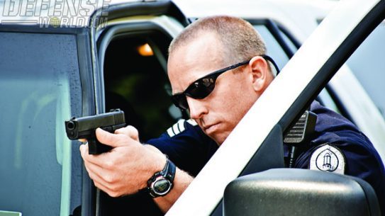 The use of excellent tactics are a must when using an outstanding duty pistol such as the GLOCK—here, this officer has made full use of cover behind his vehicle during a felony takedown.