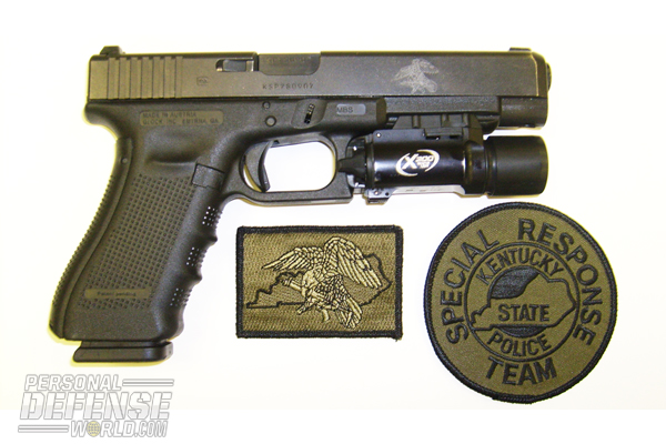 The Kentucky Special  Response Team’s issue GLOCK 35 (note the slide marking) and agency uniform patches.