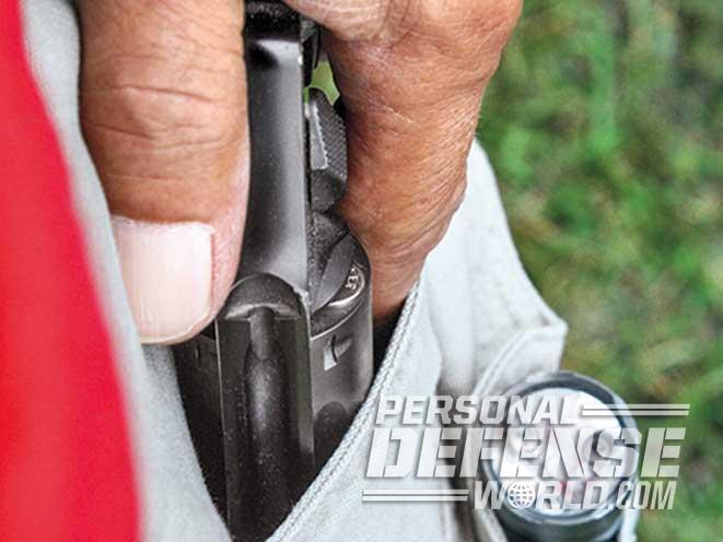 Small revolvers are easy to carry in a front trouser pocket, as the author demonstrates with his S&W M&P340 in a Safariland holster.