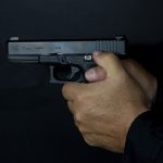 Pistol grip ways to hold a handgun interlocked thumbs