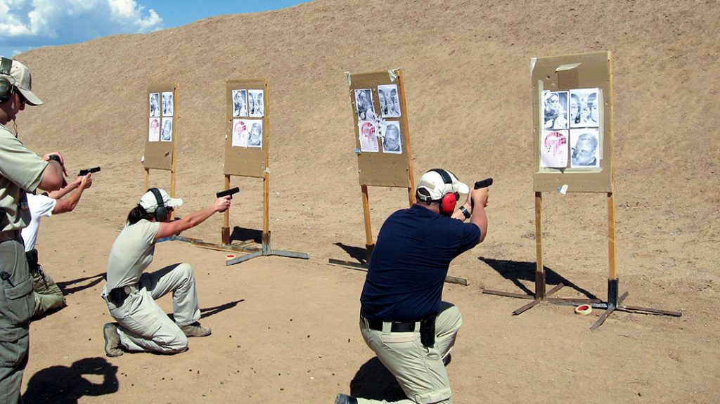 Students practice shooting from a kneeling position.