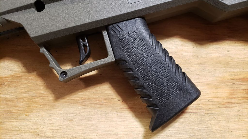The Apex uses an AR15 pattern pistol grip and a simple cross bolt safety.